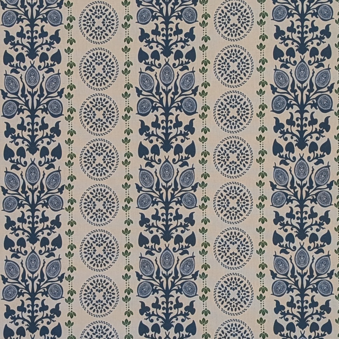 Patterned fabric with blue and green design on a beige background