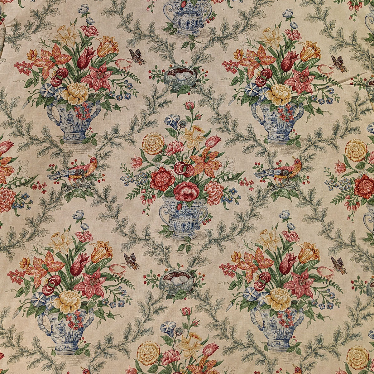 Floral patterned fabric with flowers in vases and butterflies on a beige background