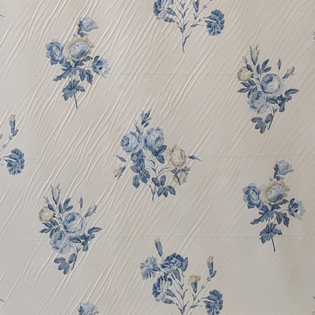 Blue floral pattern on a textured beige background