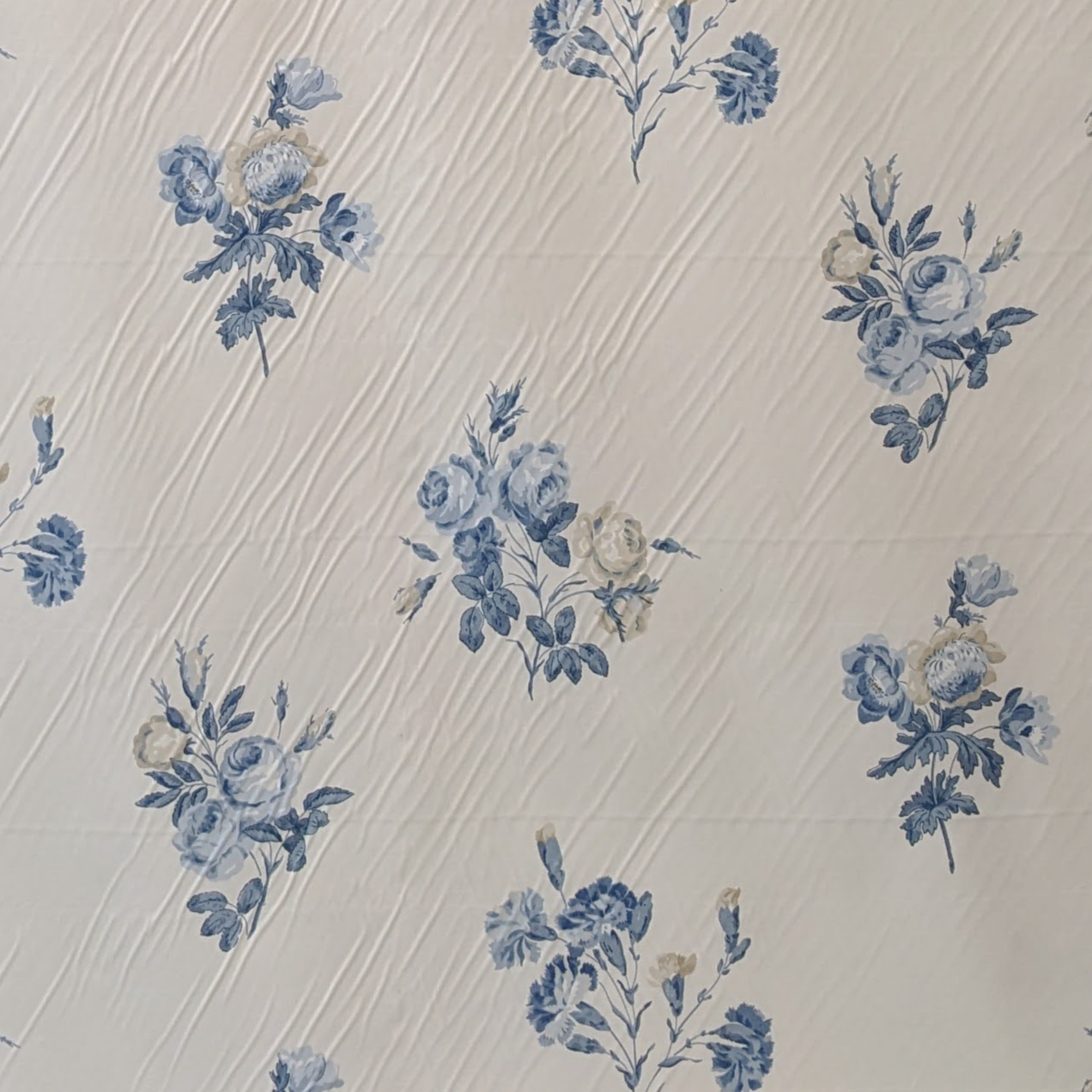 Blue floral pattern on a textured beige background
