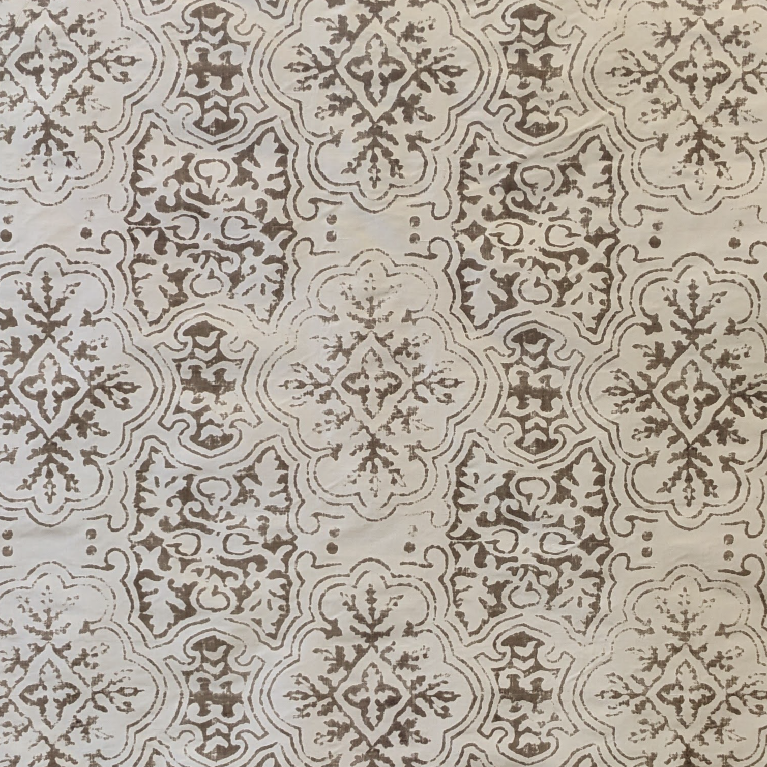 Decorative pattern with intricate designs on a beige silk background