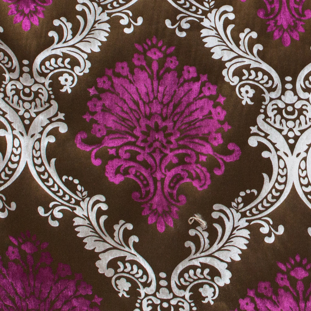 Decorative fabric with purple and white floral pattern on a brown background