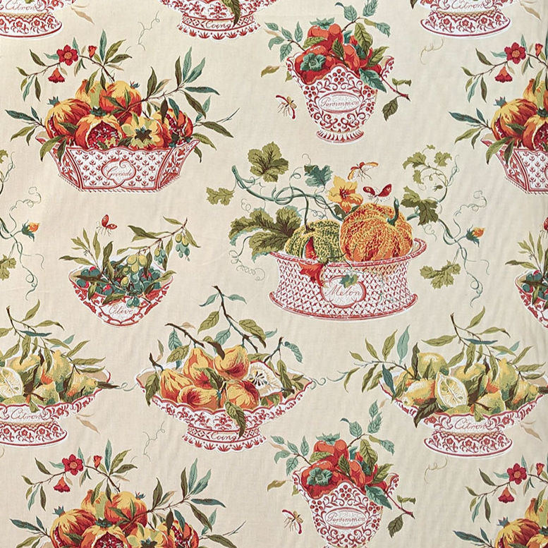Patterned fabric with fruit and flower design on a beige background