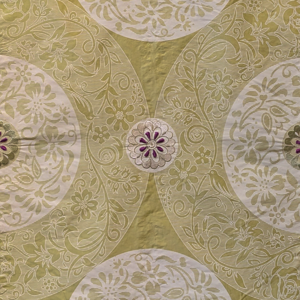 Patterned fabric with circular designs on a green background