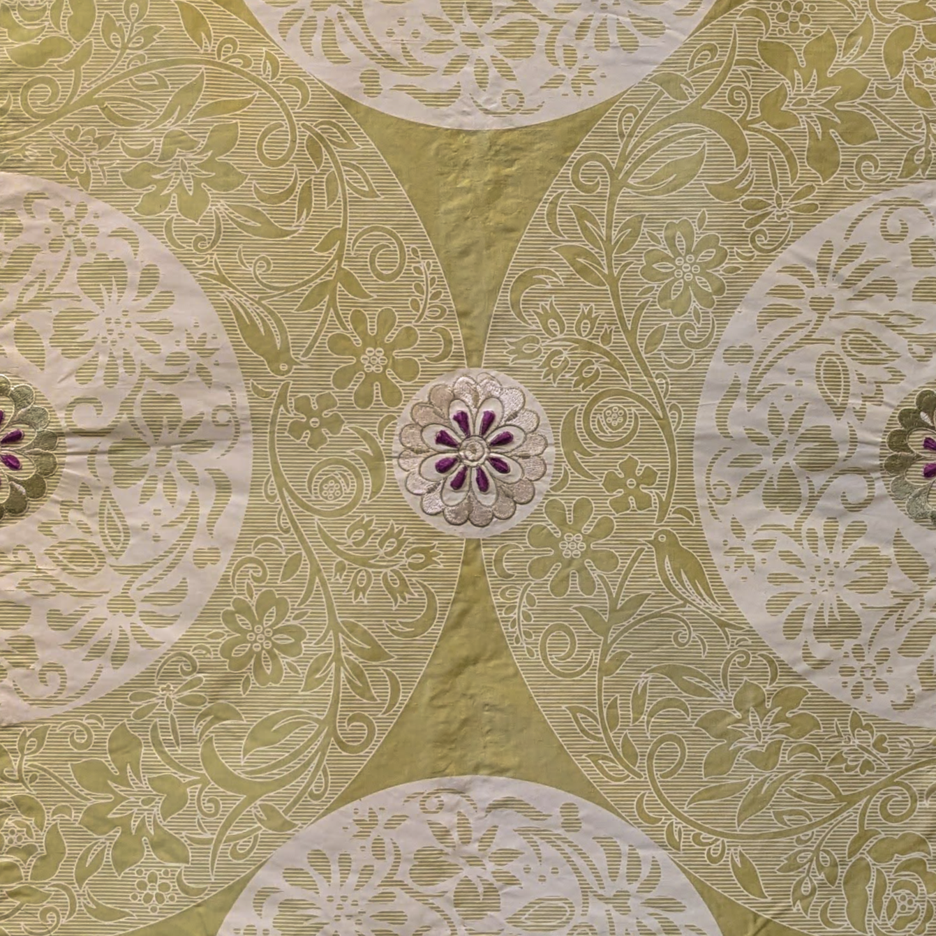 Patterned fabric with circular designs on a green background