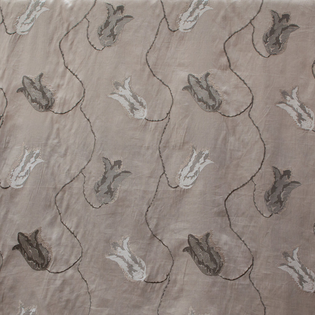Textured fabric with embroidered floral pattern on a beige background