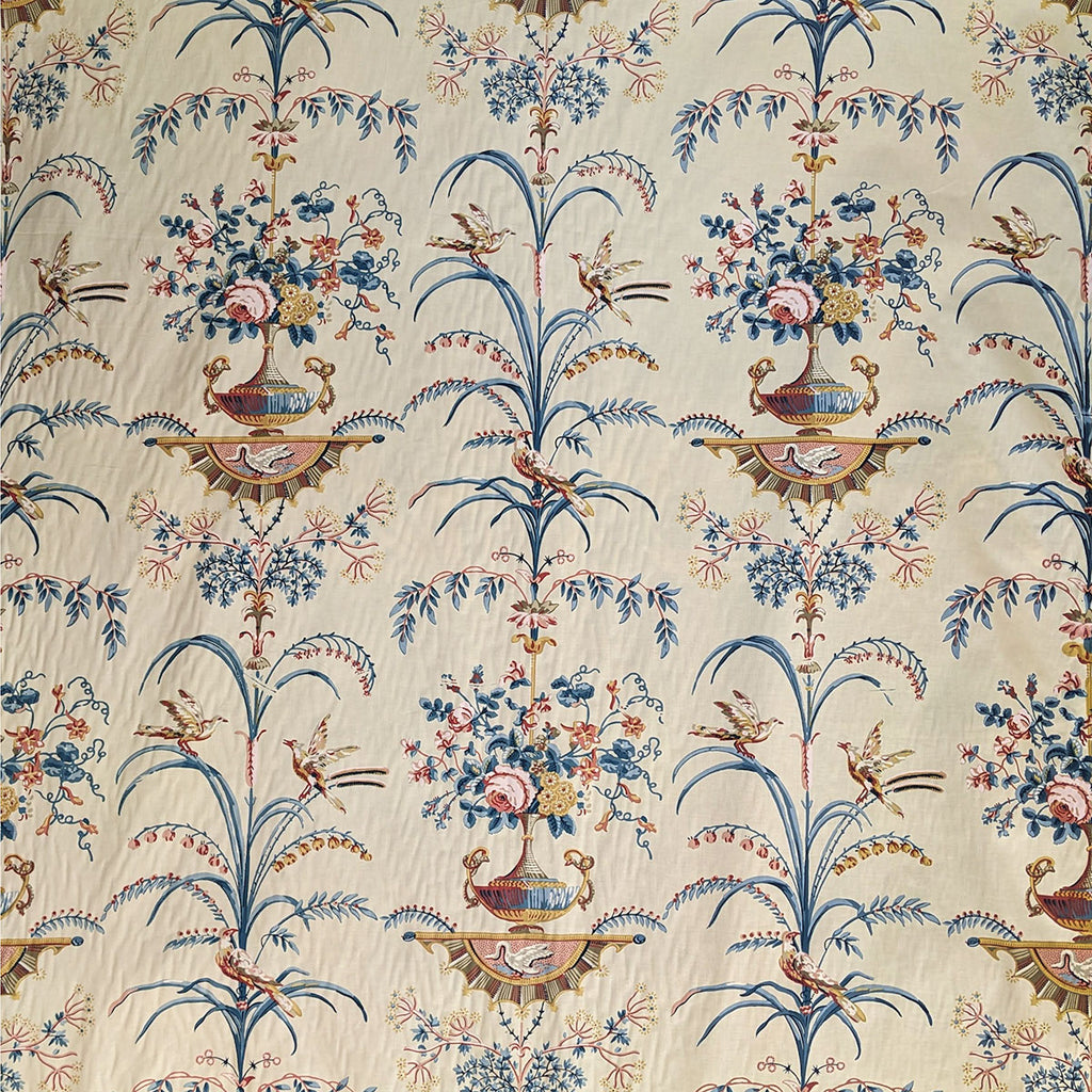 Tall grasses and vases with blue and brown flowers in on cream background 