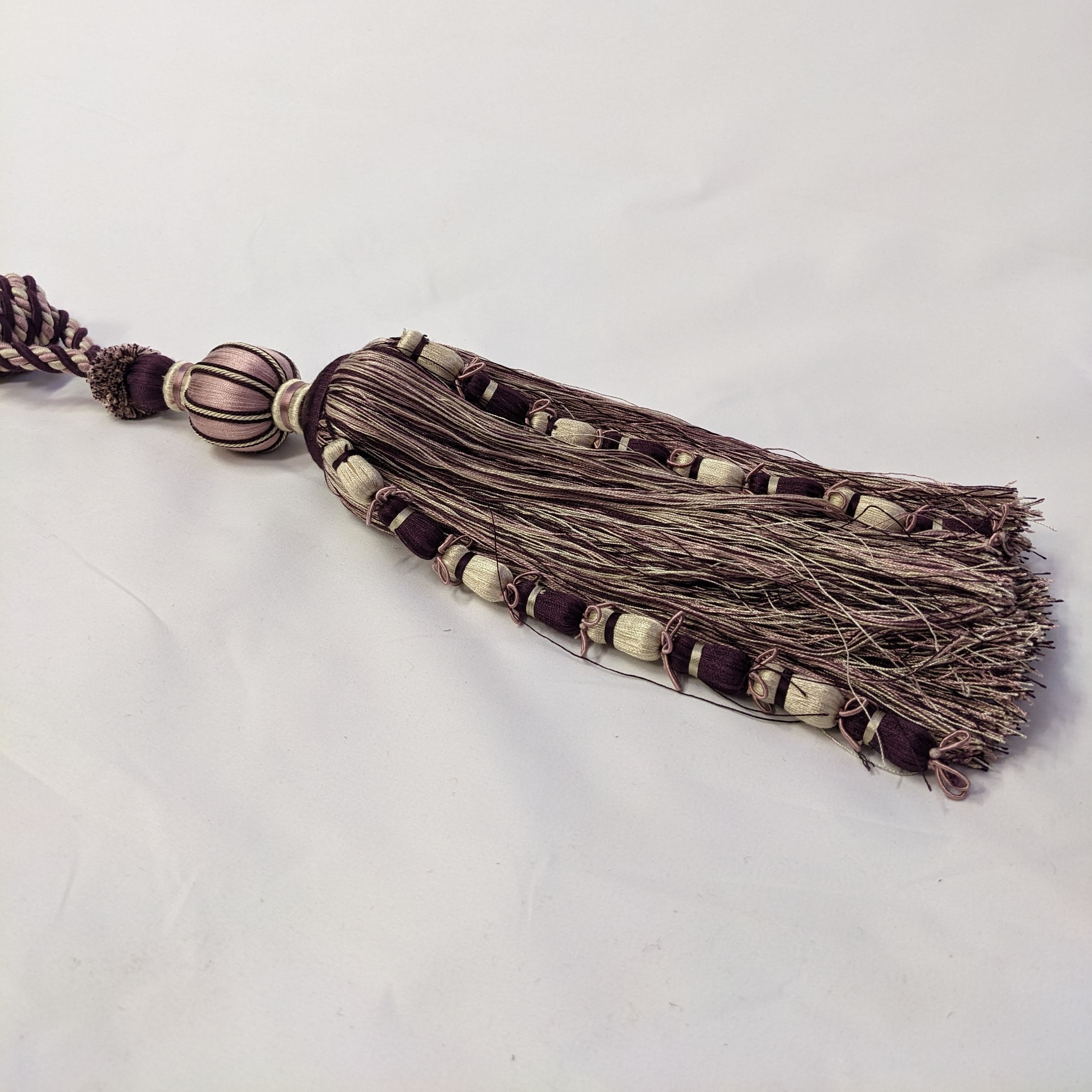 Decorative tassel with beads on a white background