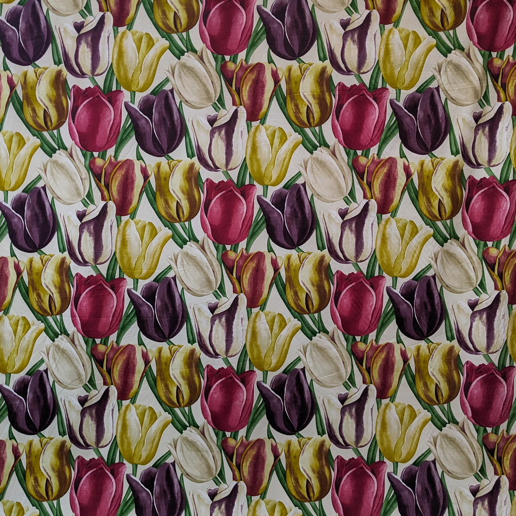 Pattern of multicolored tulips on a fabric background