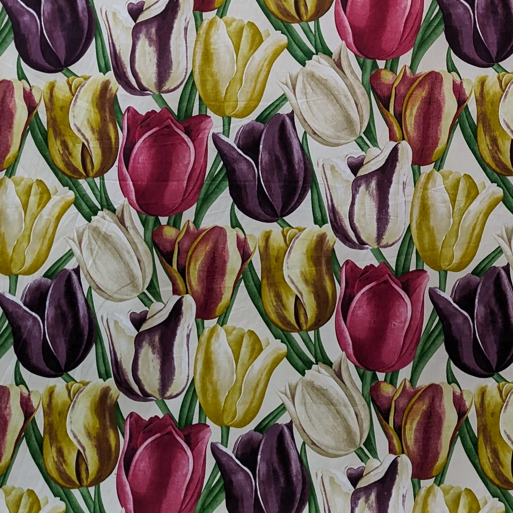 Pattern of multicolored tulips on a fabric background