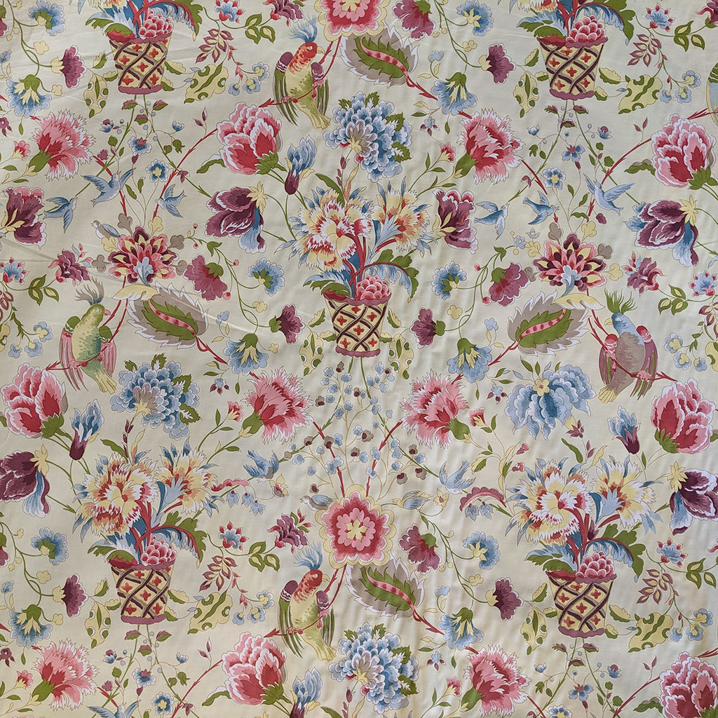 Bird and flowers in baskets with purple, blue and pink with a cream background fabric