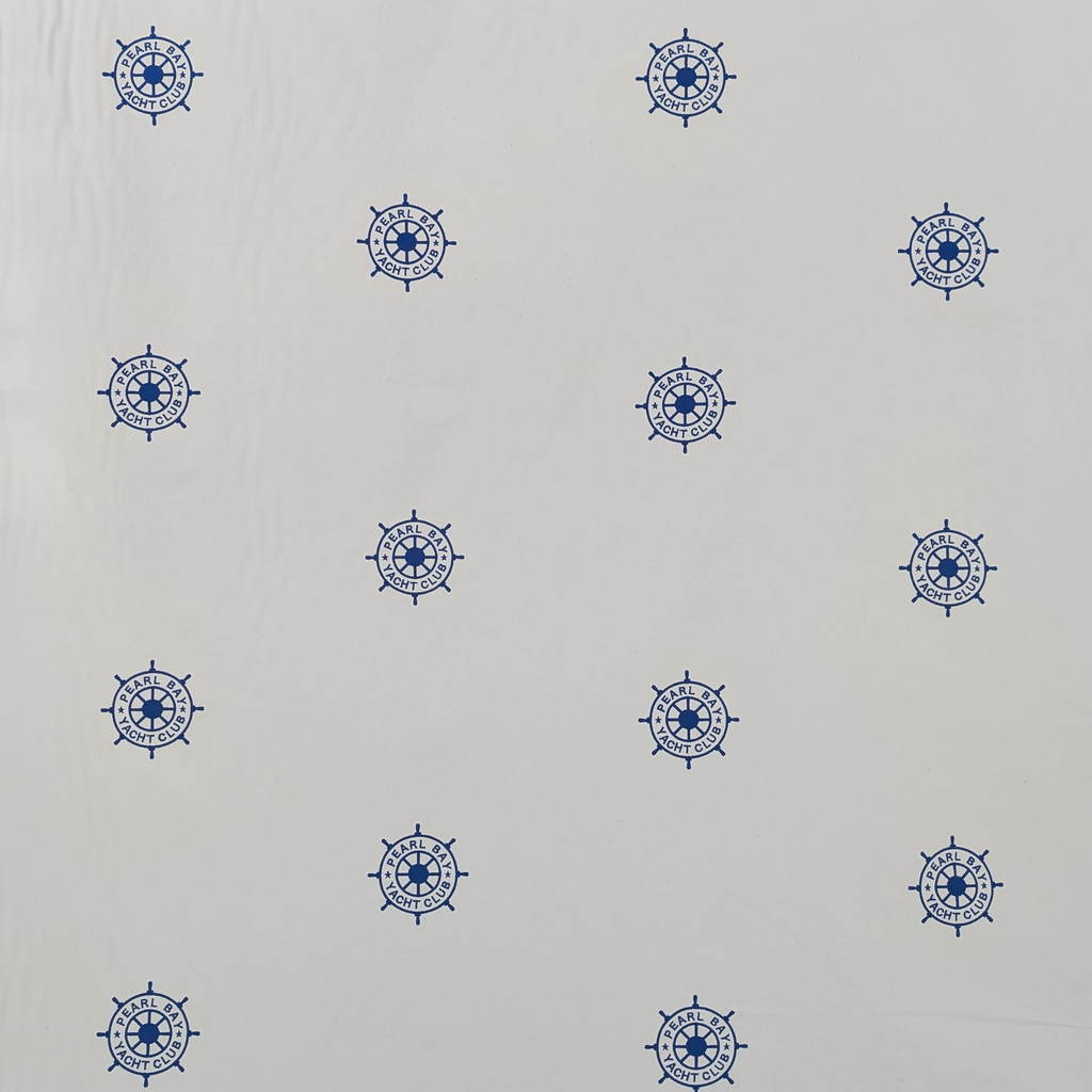 Embroidered Blue ships steering wheel logo on a white background