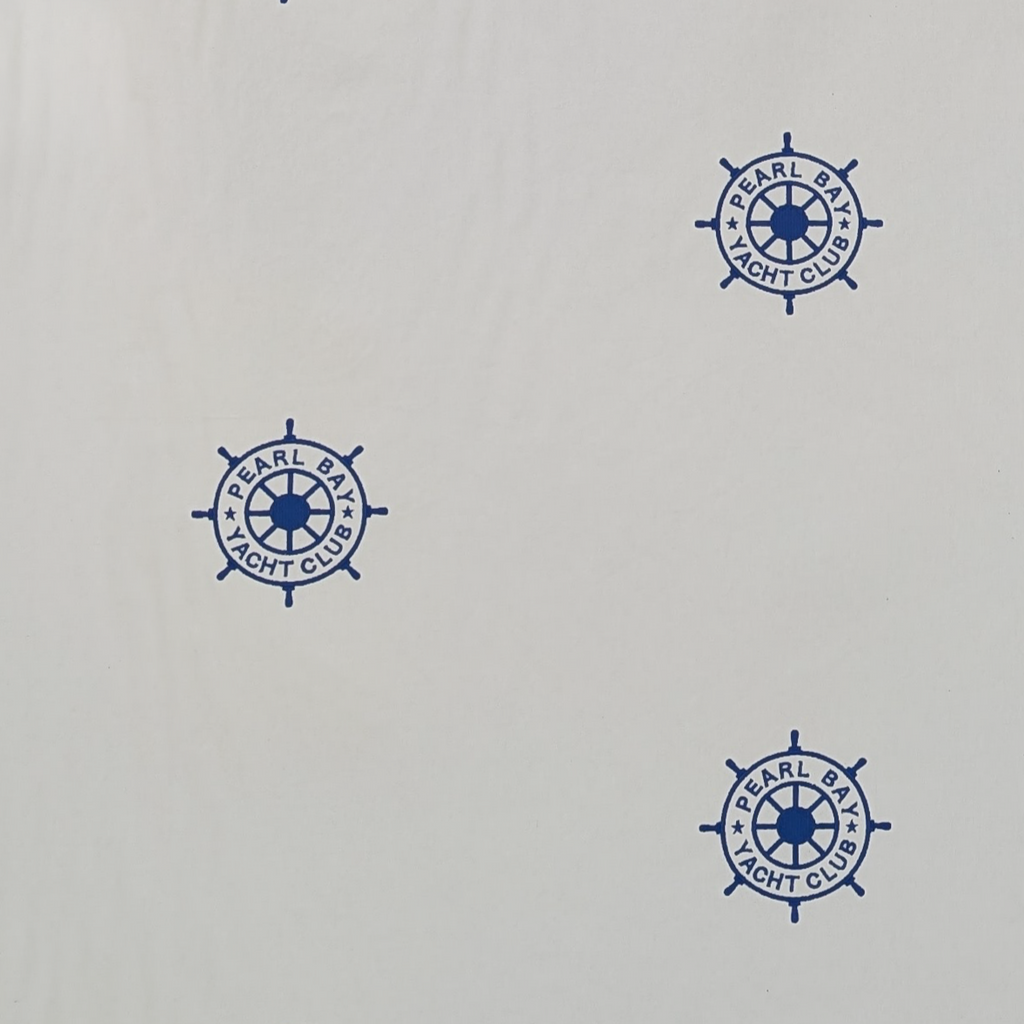 Embroidered Blue ships steering wheel logo on a white background
