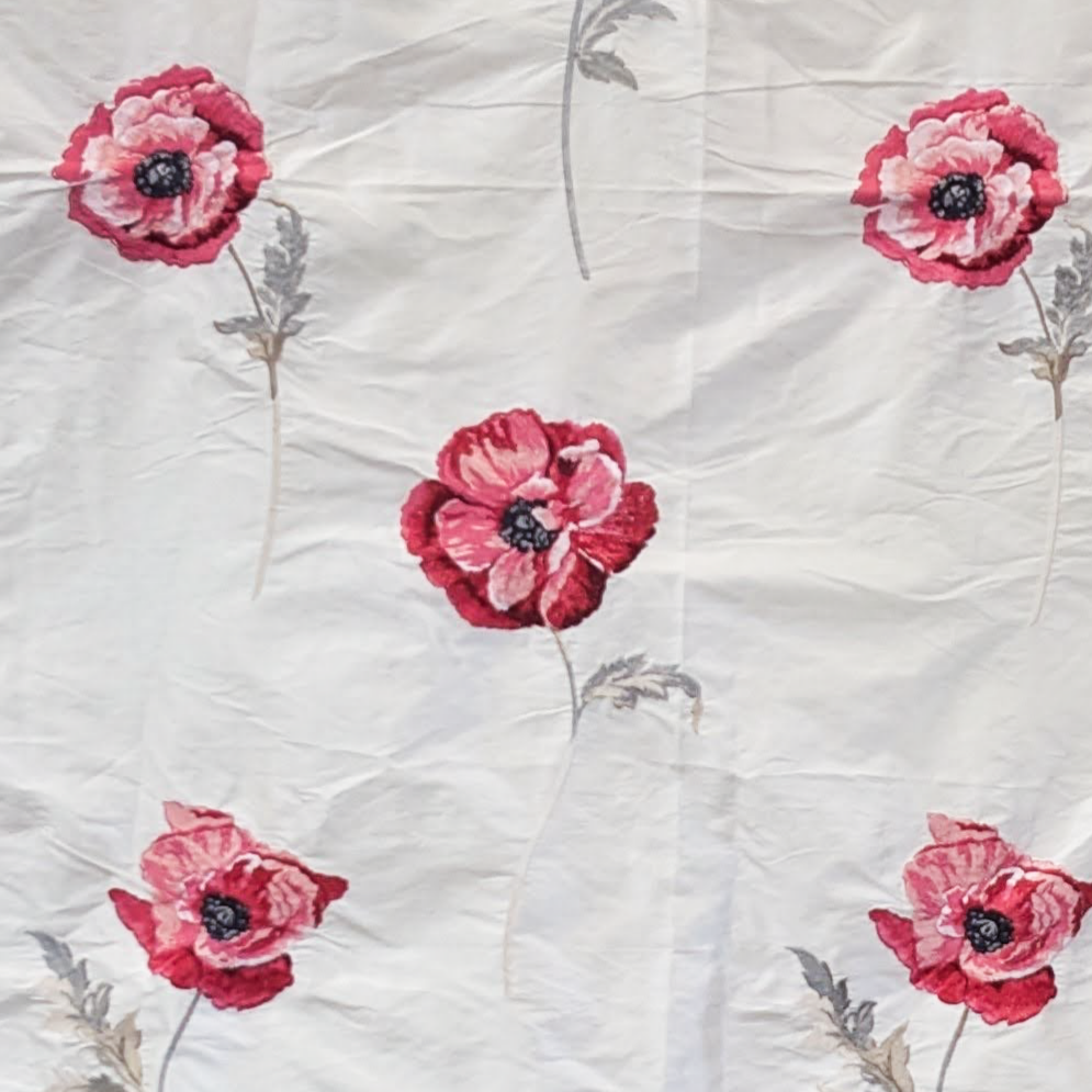 Pattern of red flowers with green stems on a textured white fabric background