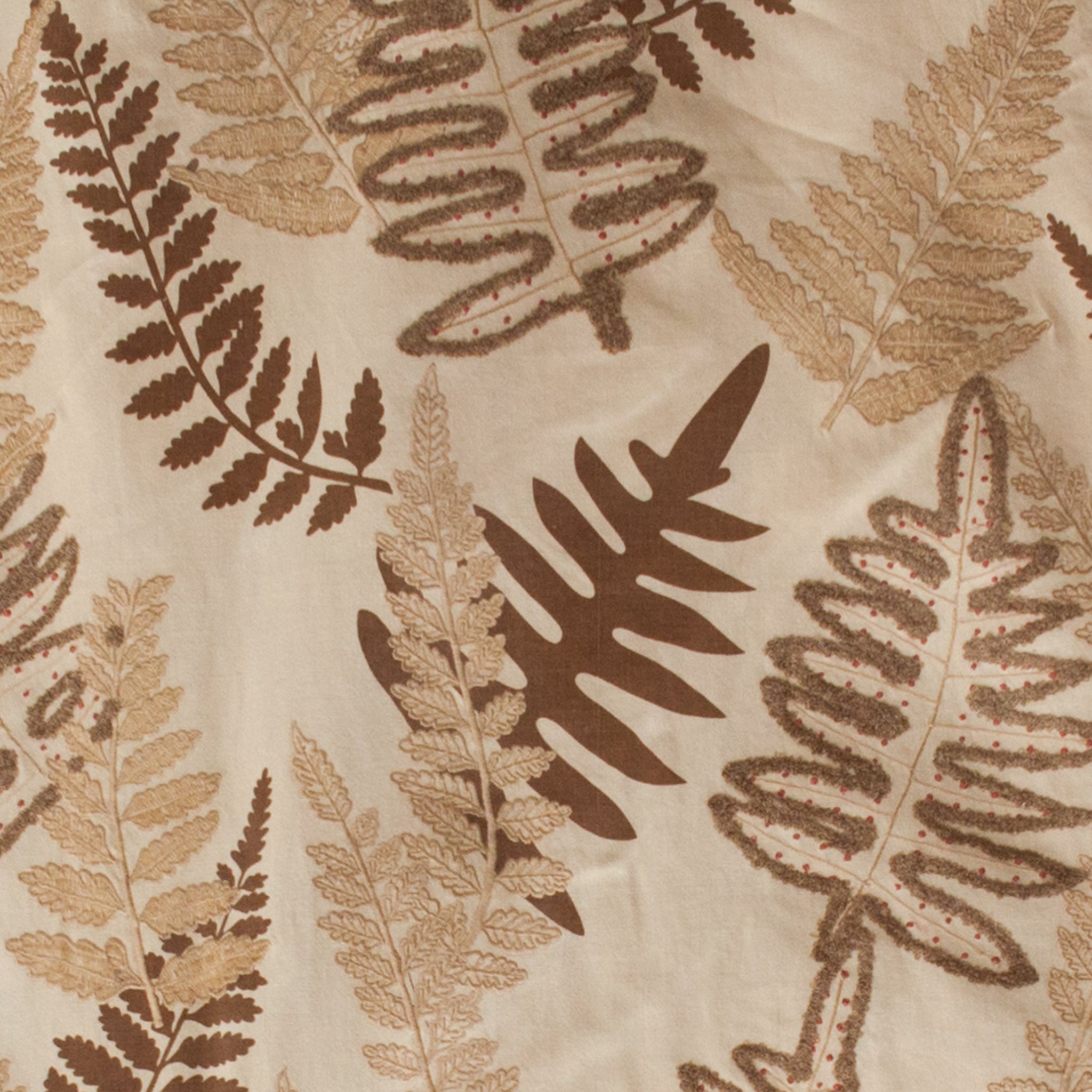 Pattern of brown and beige fern leaves on a textured fabric background