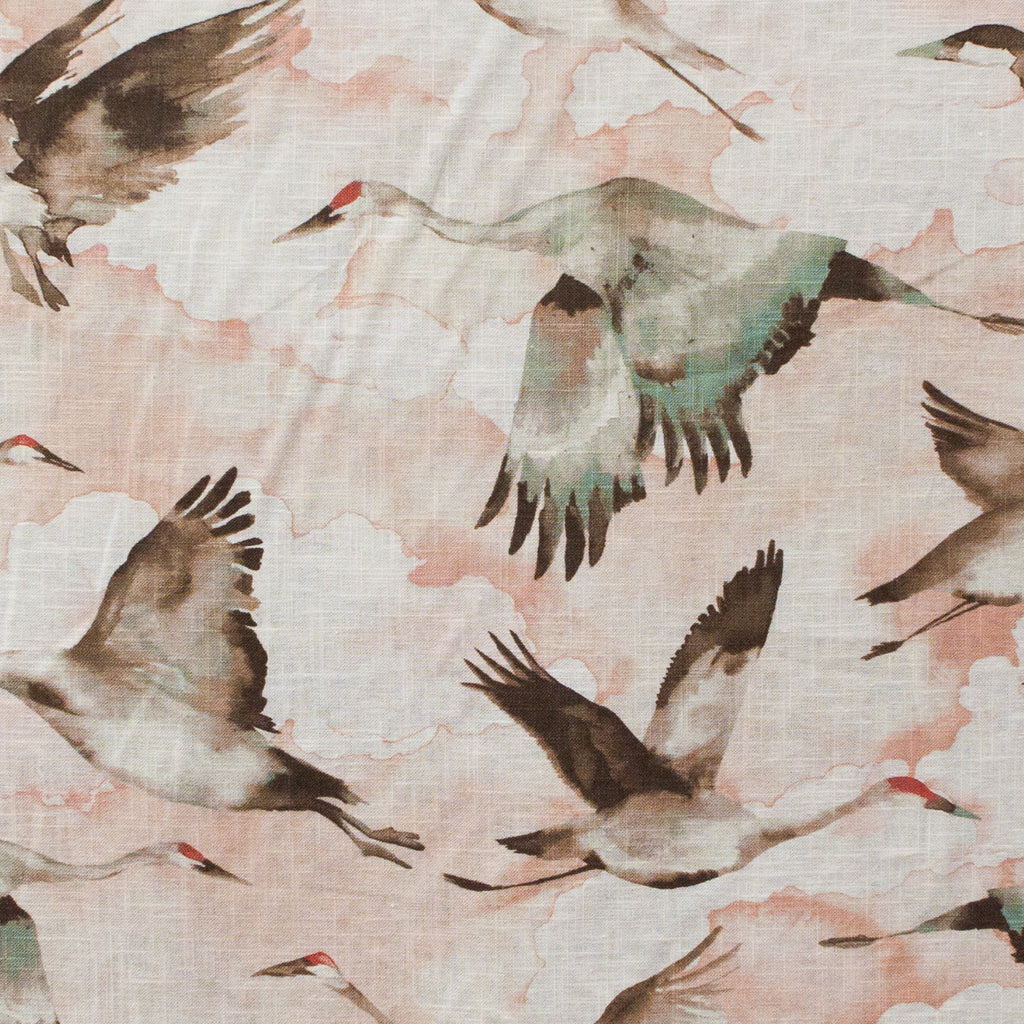 Pattern of cranes flying over cloud background