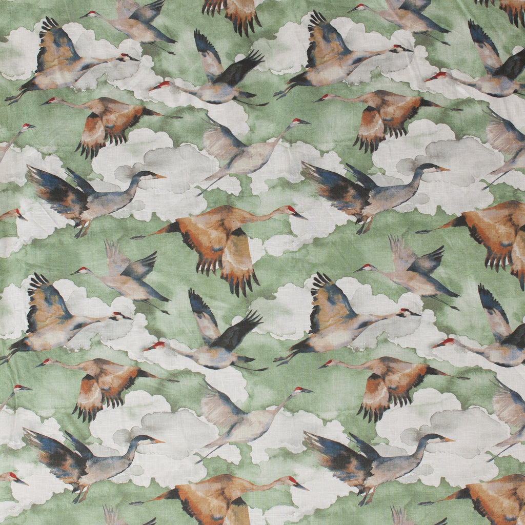 Pattern of cranes flying on a green background