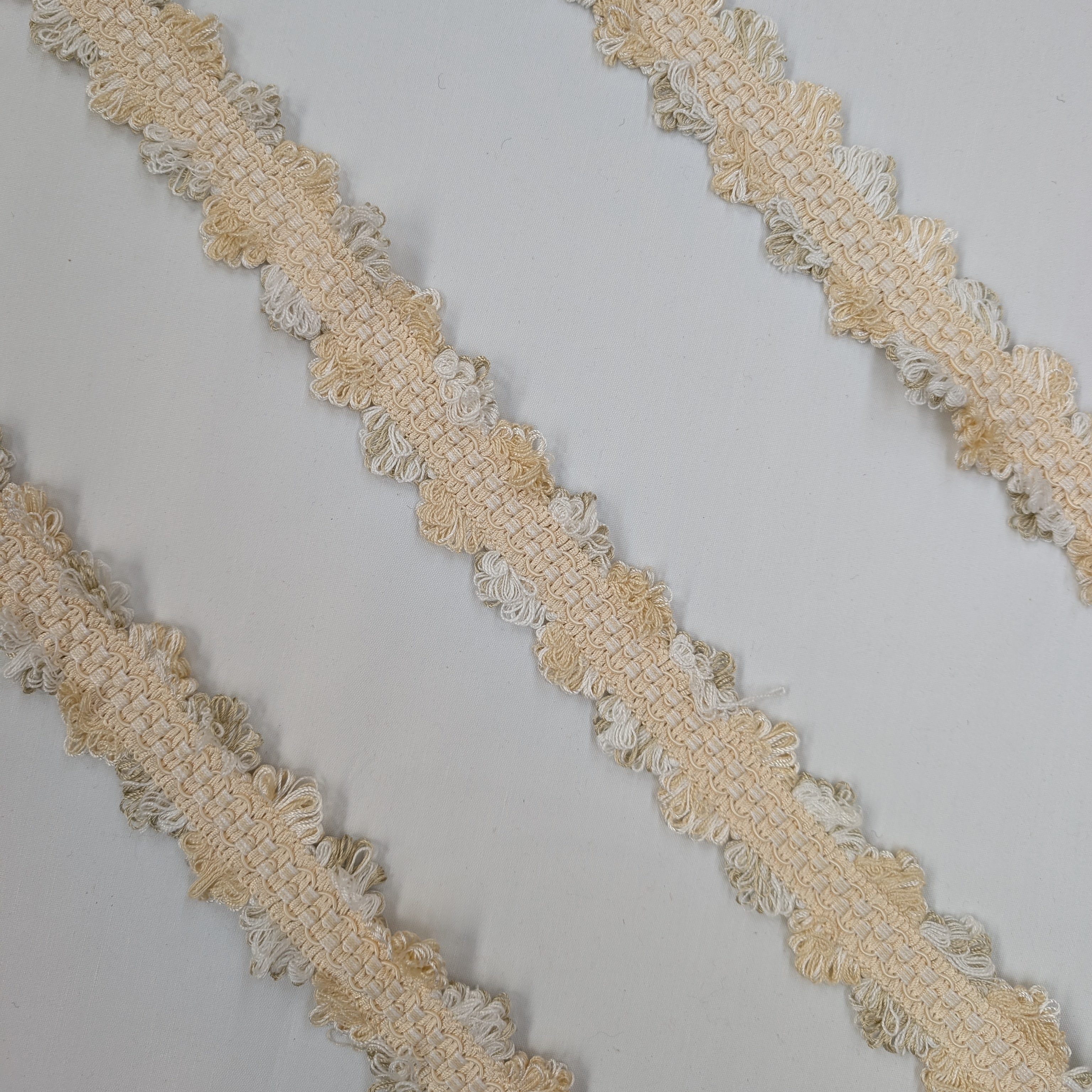 Beige lace trim on a light gray background