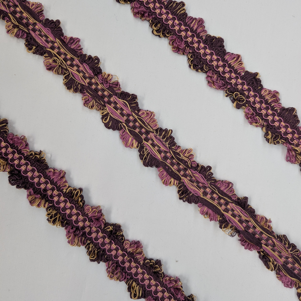 Decorative trim with purple and gold pattern on a white background