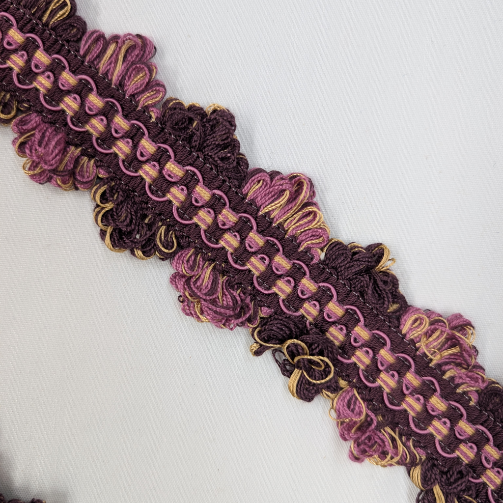 Decorative trim with purple and gold pattern on a white background