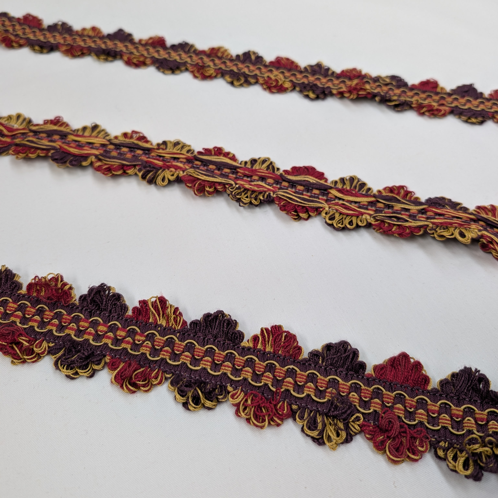 Decorative trim in red, gold, and brown on a white background