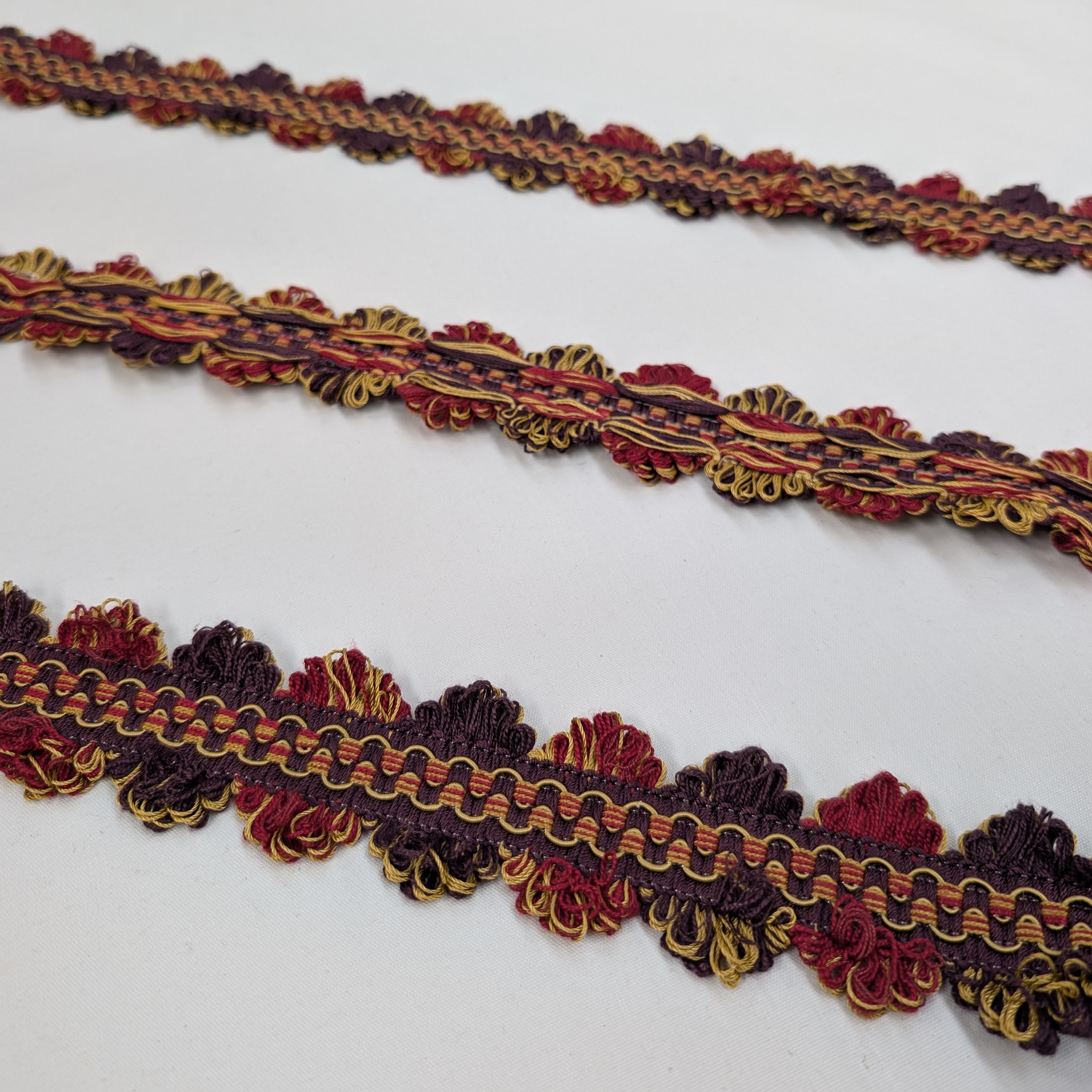 Decorative trim in red, gold, and brown on a white background