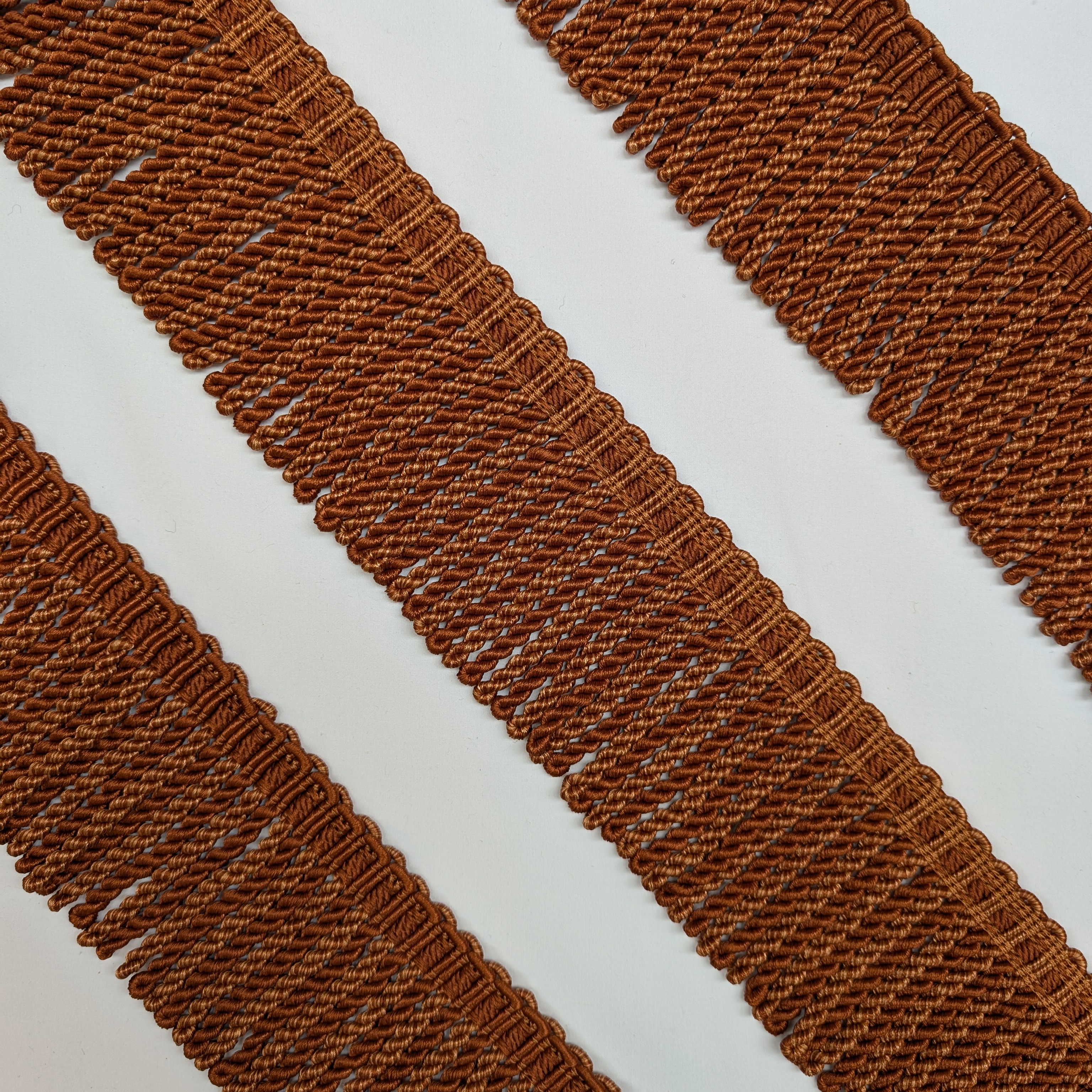 Close-up of brown textured fabric strips on a white background