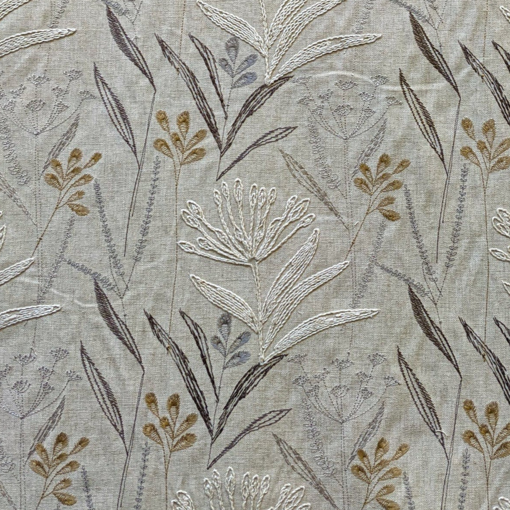 Embroidered flowers and grasses in natural linen and brown tones 