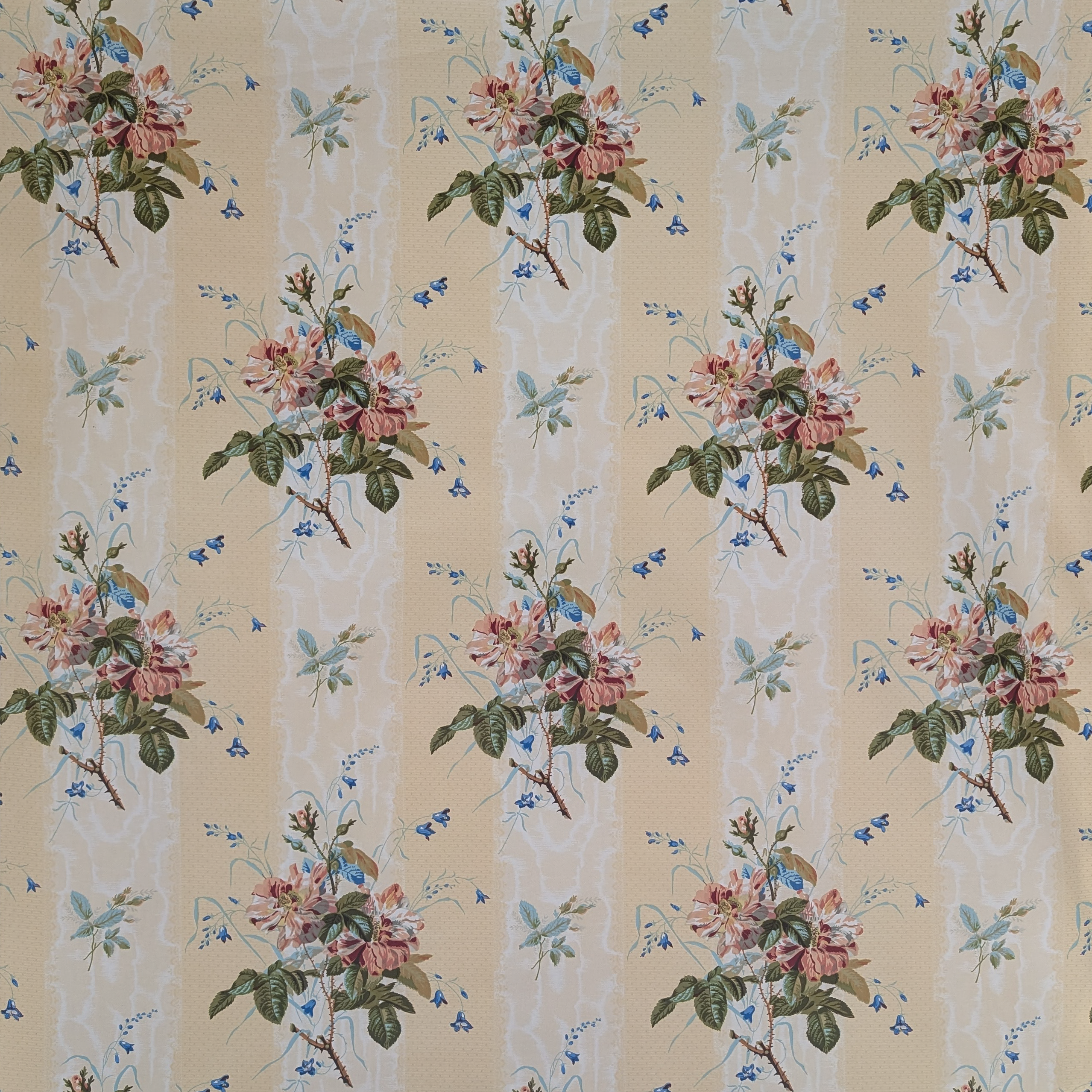 Floral patterned fabric with pink flowers and green leaves on a beige background