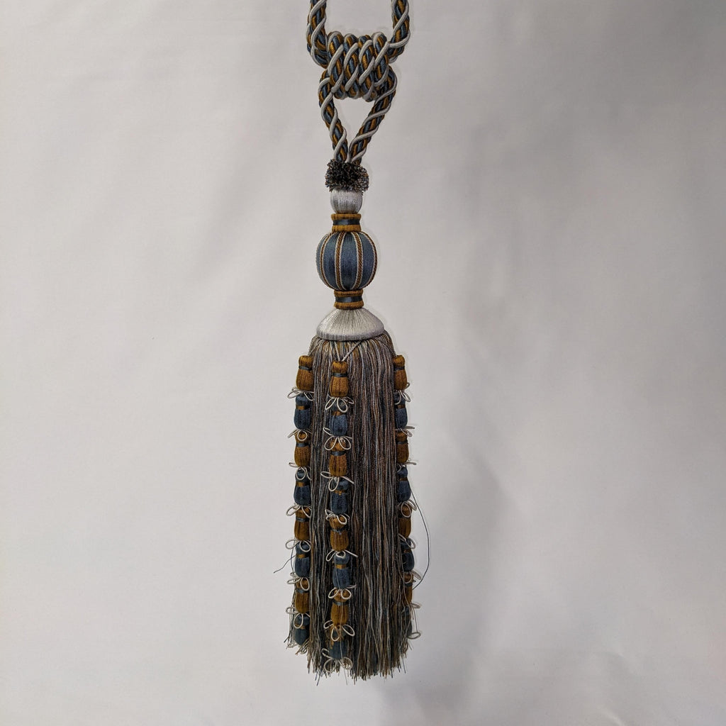 Decorative tassel with braided rope on a white background