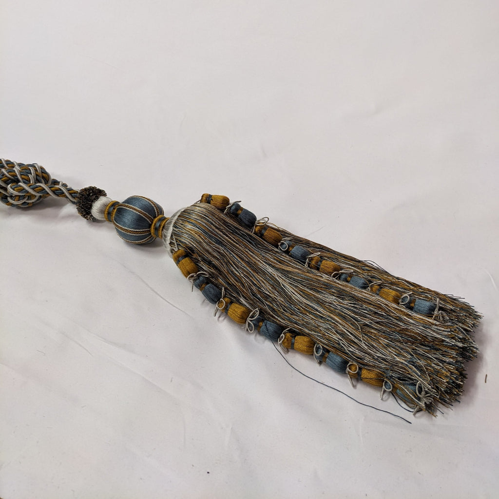 Decorative tassel with beads on a white background