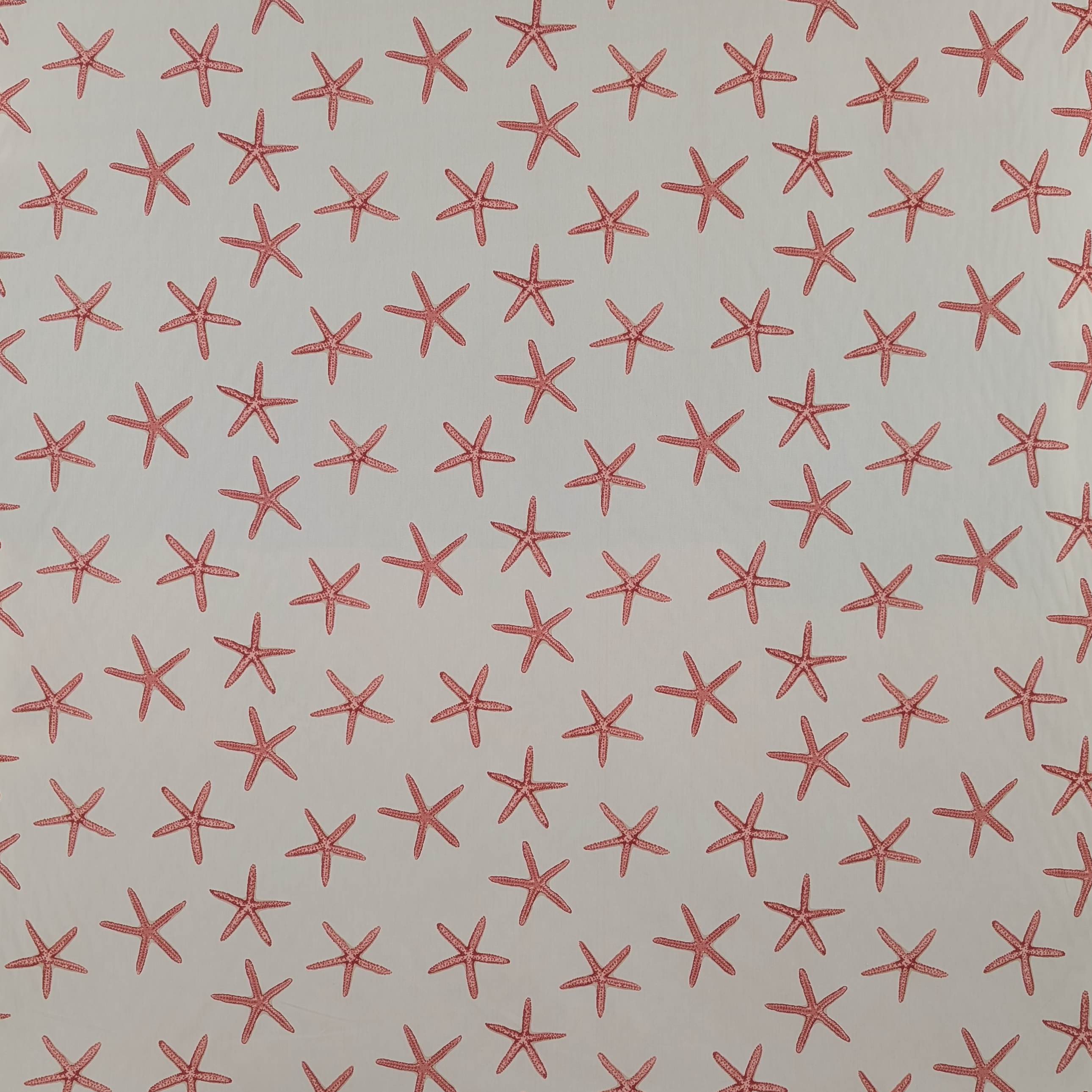 Pattern of red starfish shapes on a beige background