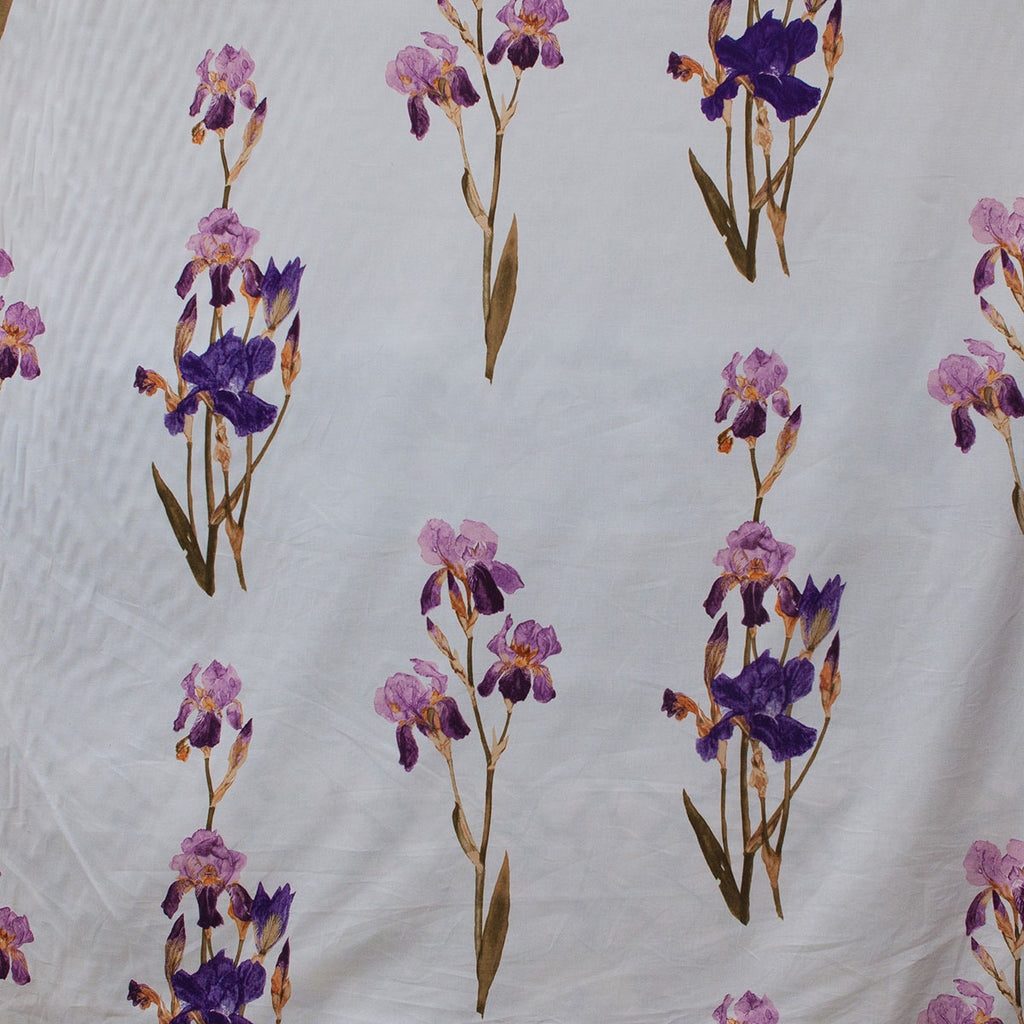 Pattern of purple and pink flowers on a textured white fabric background