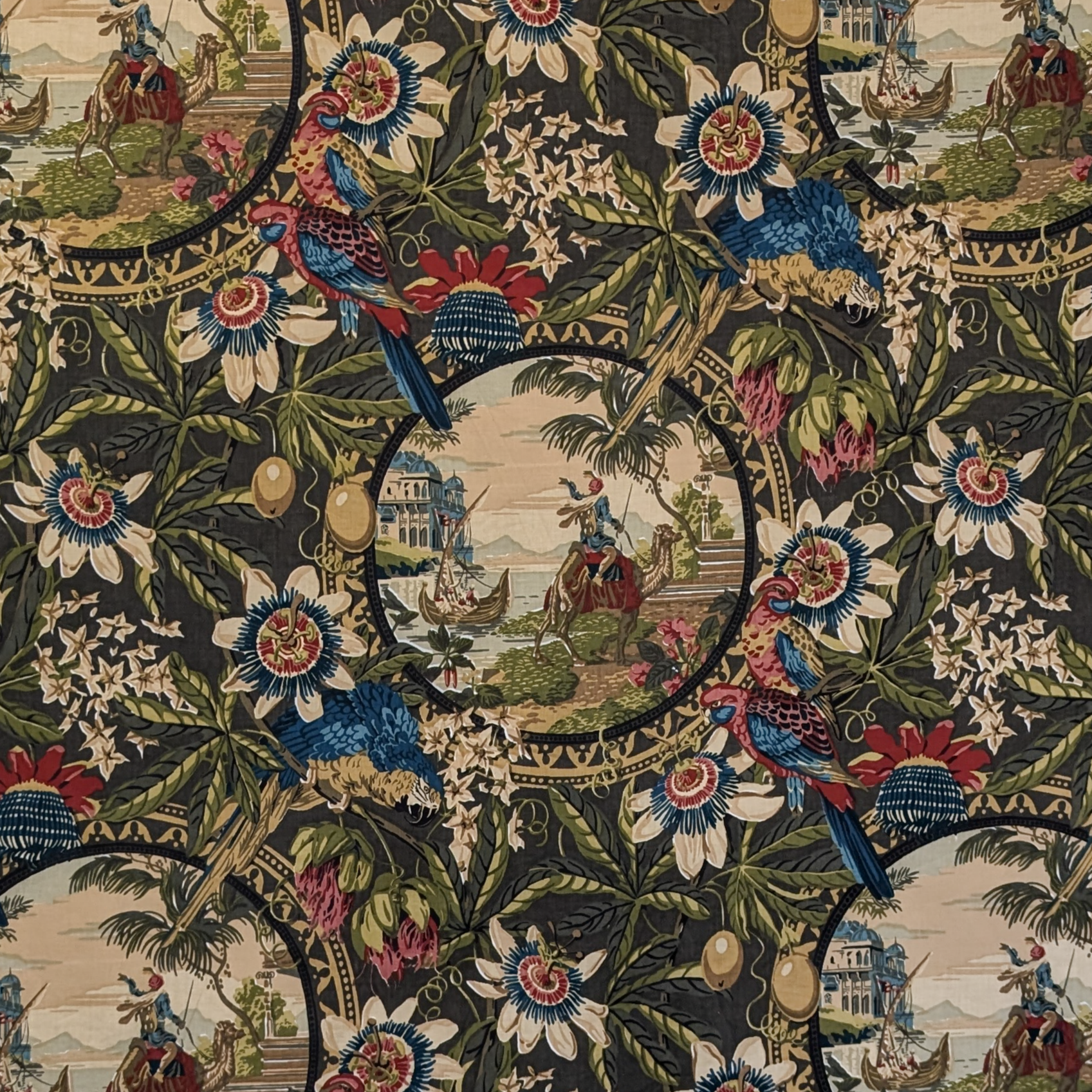 Decorative fabric with intricate patterns of birds, flowers, and landscapes.