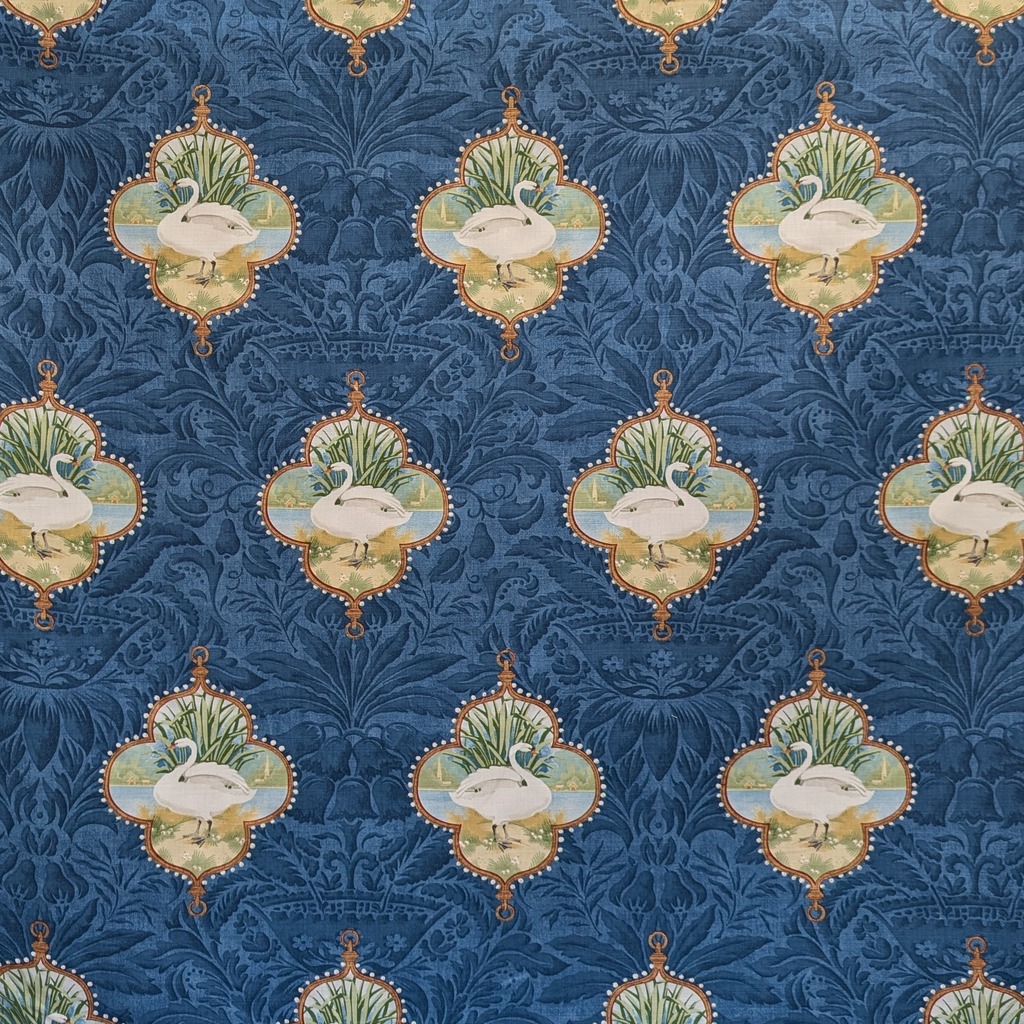 Decorative pattern with swans in ornate frames on a blue background