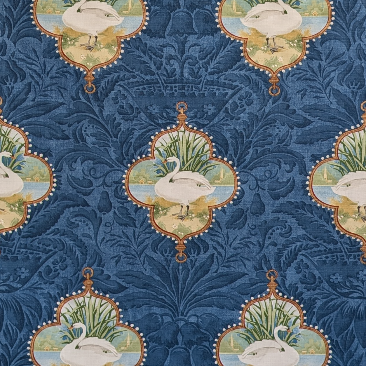 Patterned fabric with swan design on a blue background