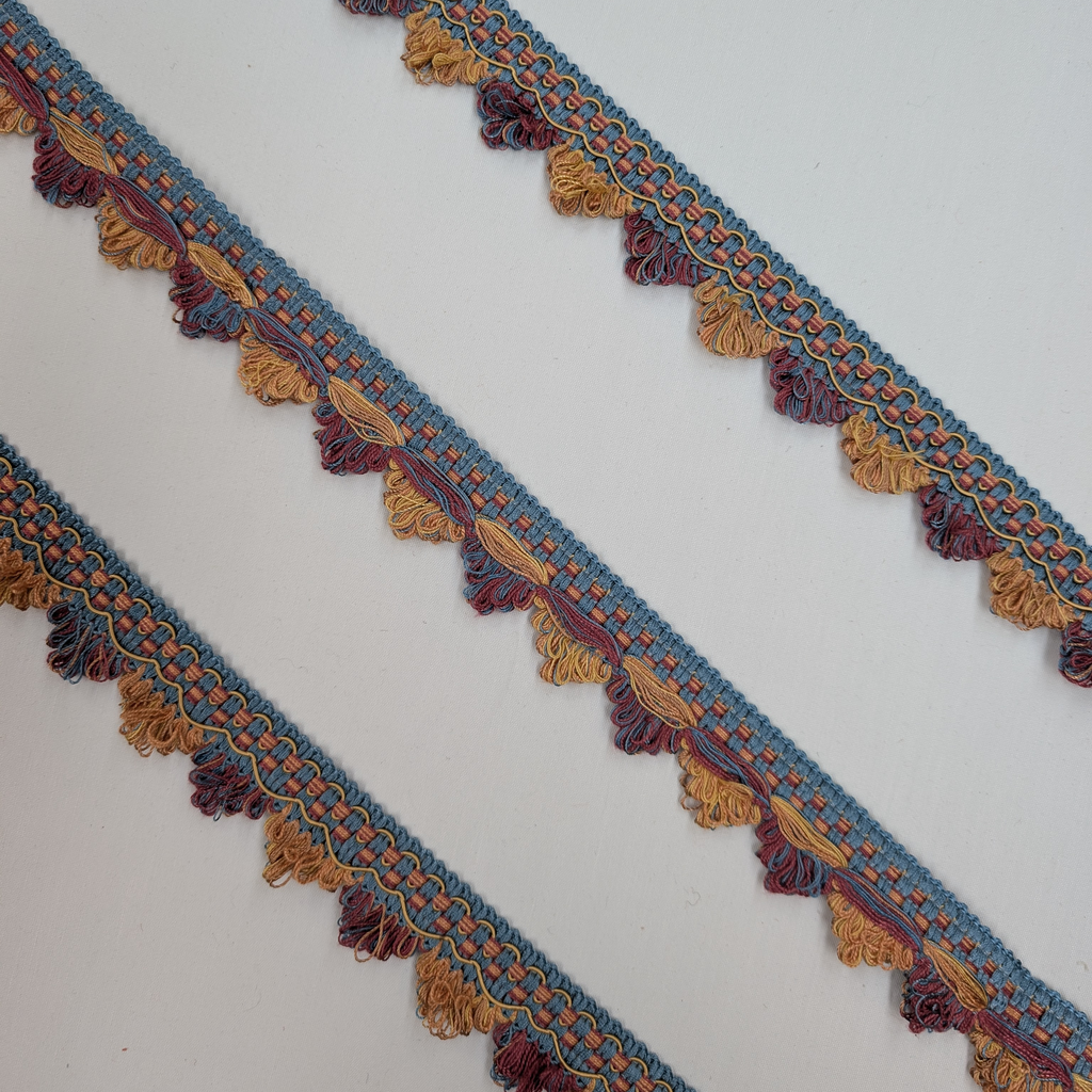 Decorative fabric trim with tassels on a white background