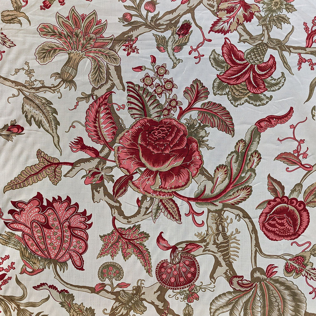 Floral and paisley pattern with red and brown colors on a light background