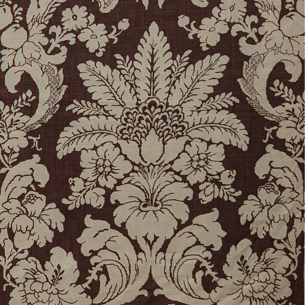 Decorative floral and leaf pattern on a brown background