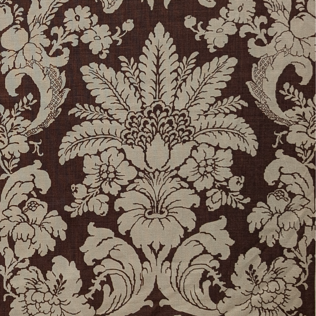 Decorative floral and leaf pattern on a brown background