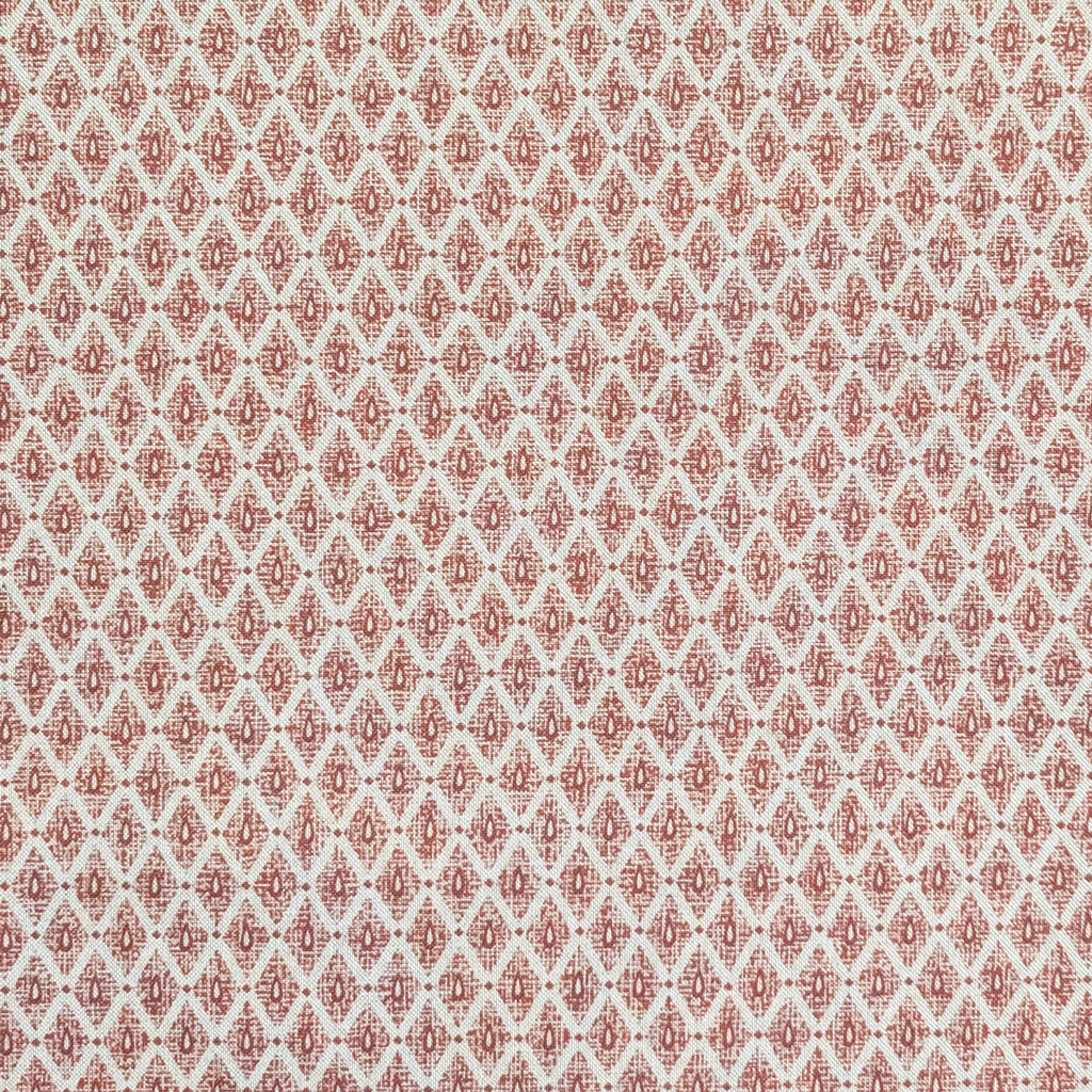 Patterned fabric swatch with red and beige design on a light background