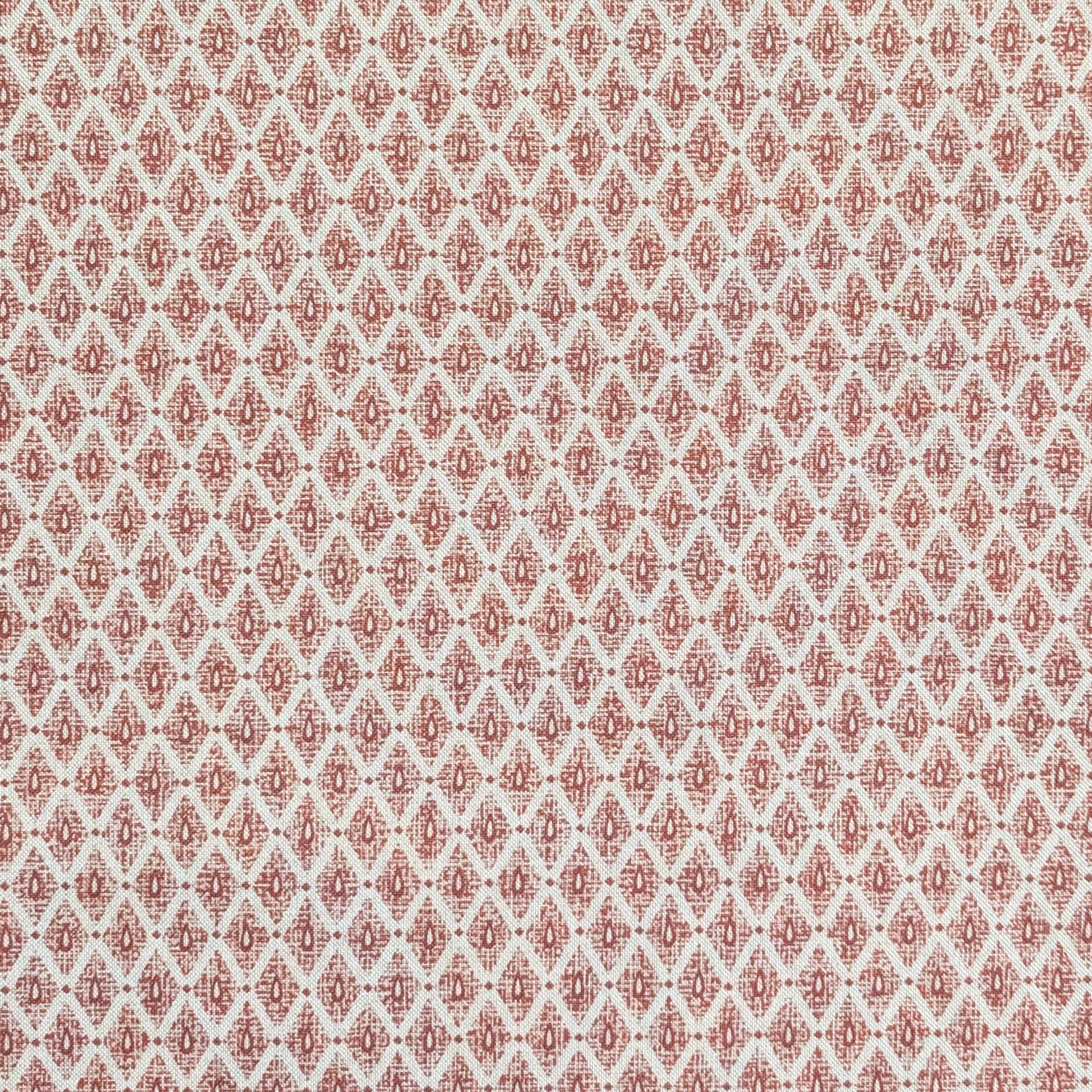 Patterned fabric swatch with red and beige design on a light background