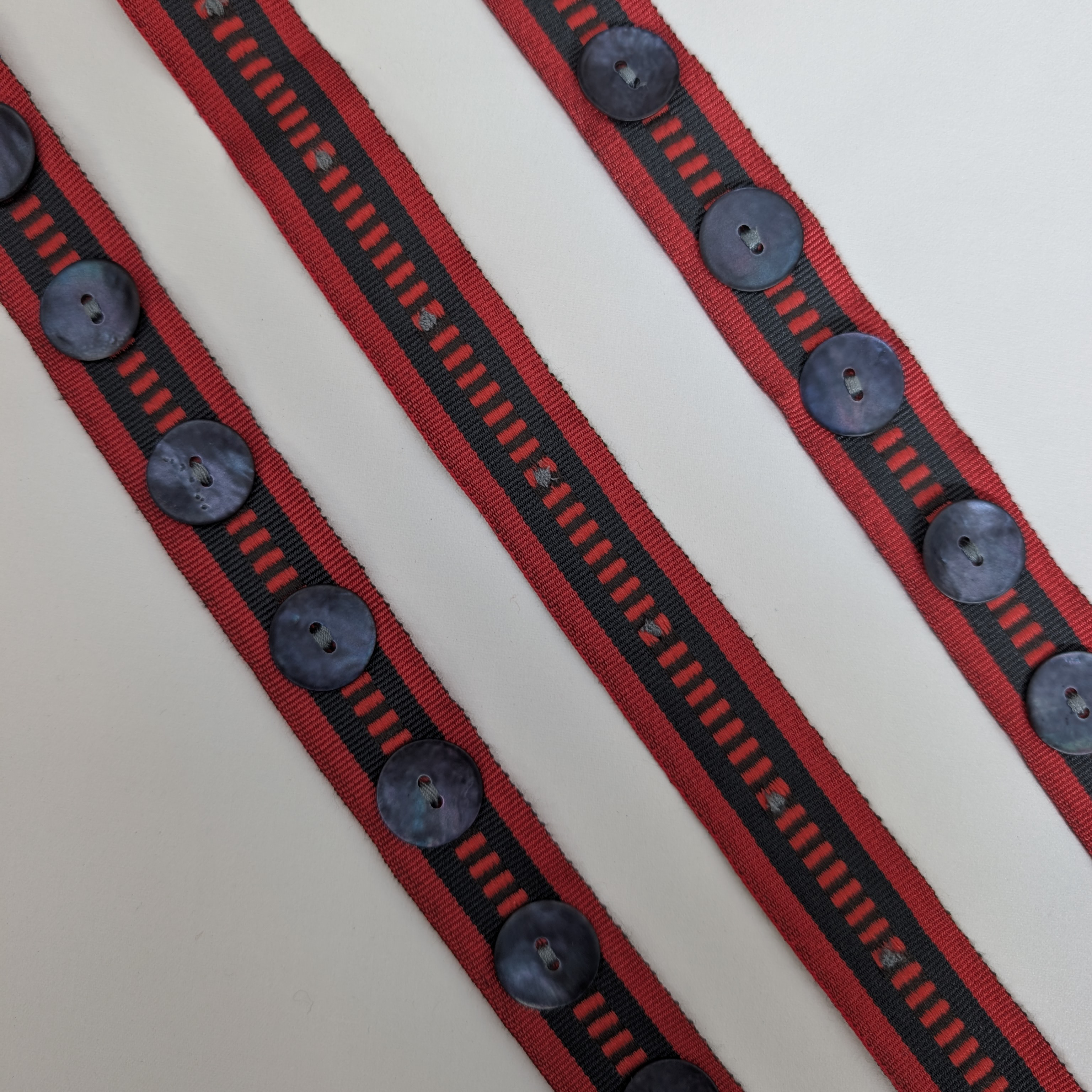 Red and black striped trim with black buttons 