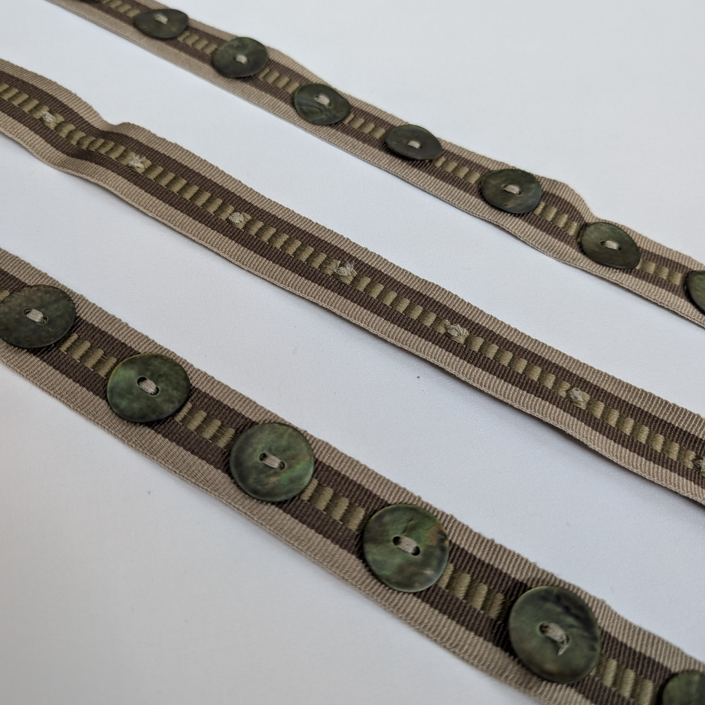 Two brown ribbons with green buttons 