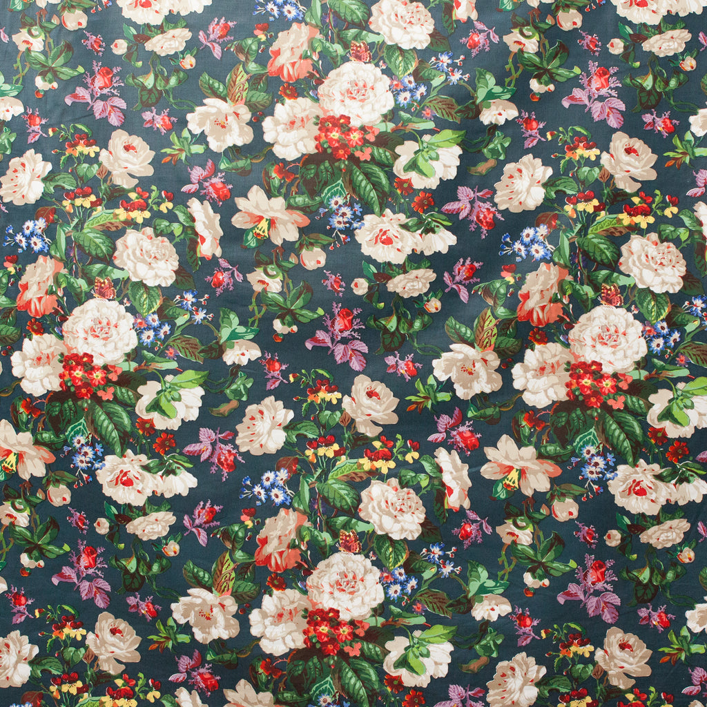 Floral patterned fabric with various flowers on a dark blue background