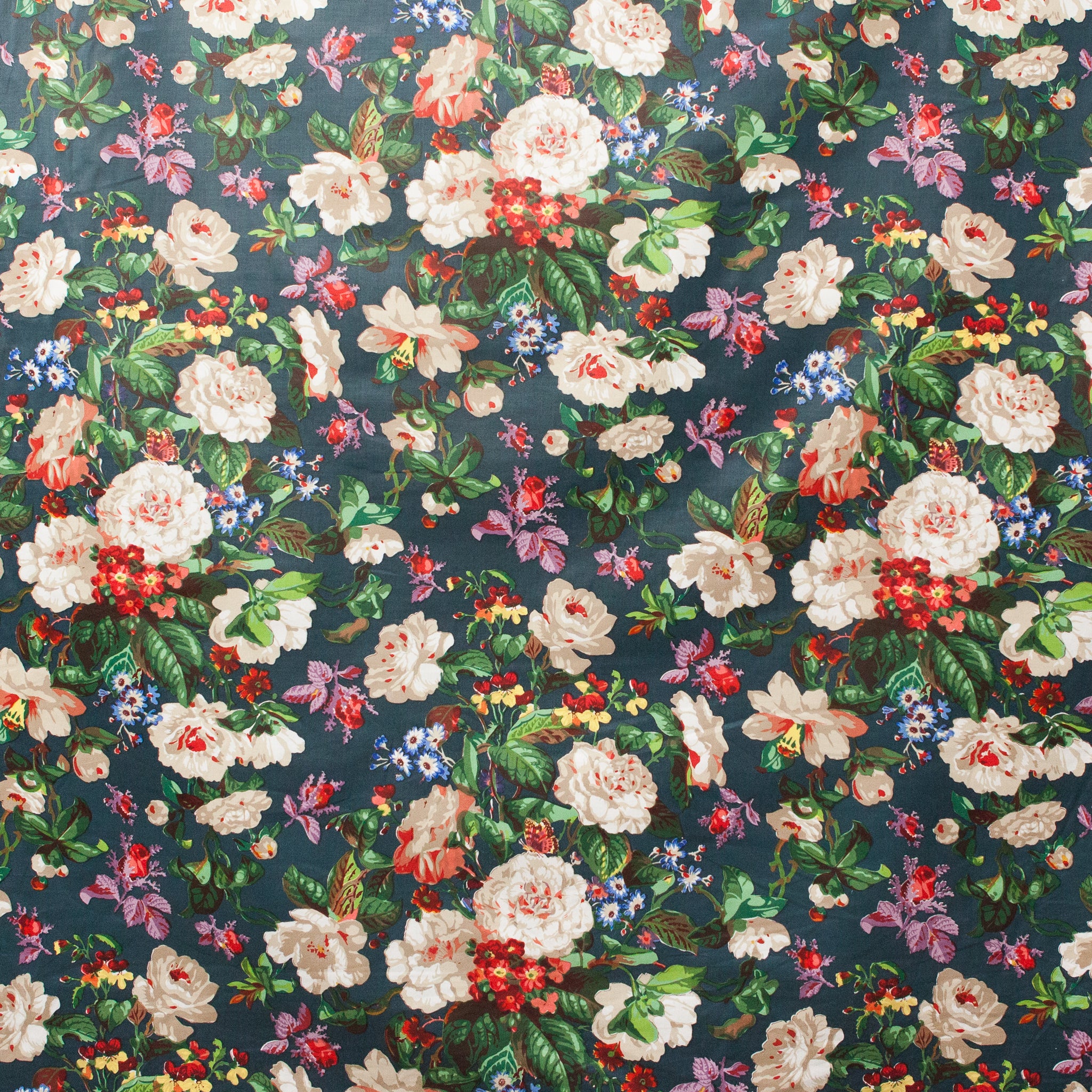 Floral patterned fabric with various flowers on a dark blue background