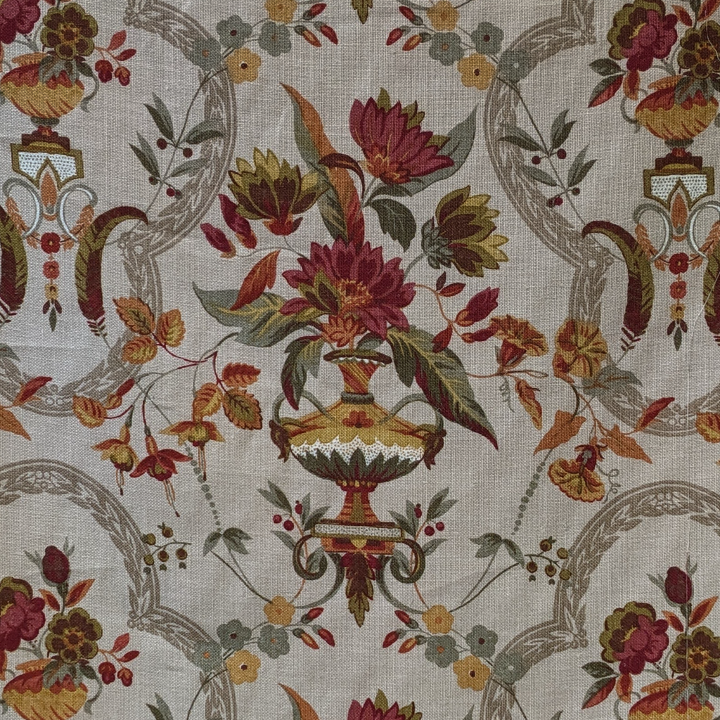 Decorative fabric with floral and urn pattern on a beige background