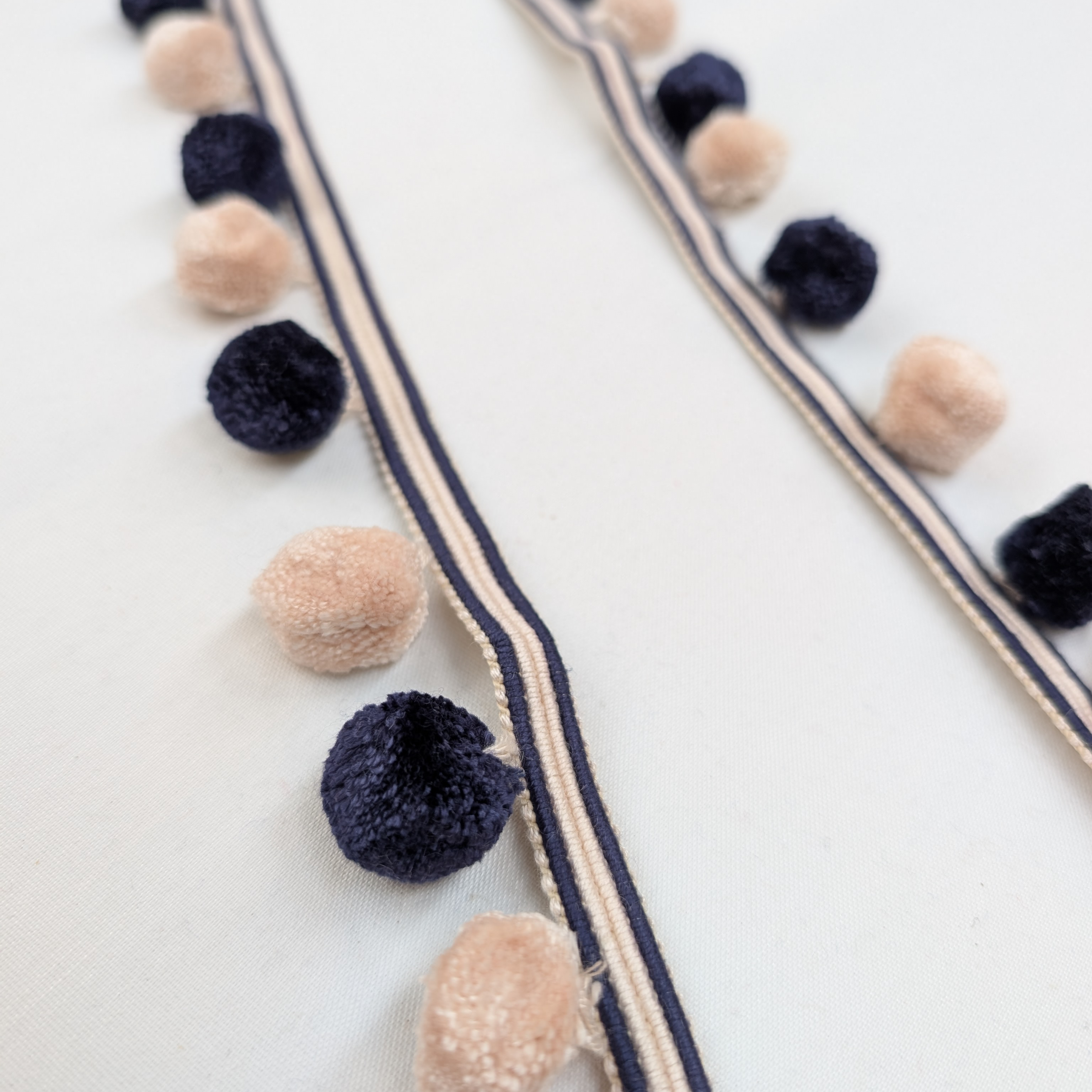 Decorative ribbon with pom-poms on a white background