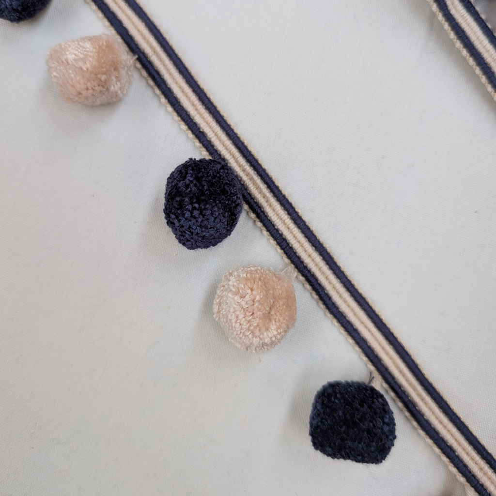 Decorative garland with pom-poms on a white background