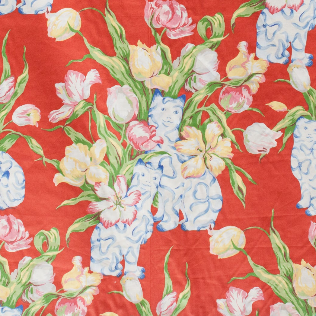 Floral pattern with blue cat figurines on a red background